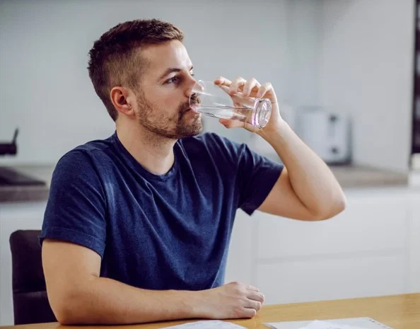 man drinking water before dna test